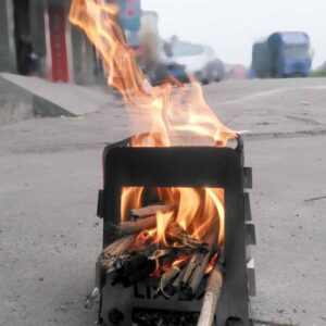 small wood stove with fire lit inside